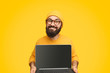 © kegfire - Smiling male showing laptop