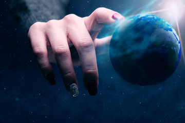 Poster - Woman touching planet with finger. Blue Nebula dust in infinite space. Mixed media.