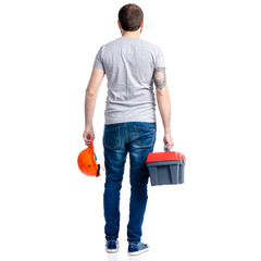 Poster - Man with building tools box and helmet in hand on white background isolation, back view