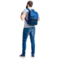 Wall Mural - A man tourist in jeans with blue backpack standing looking on white background isolation, back view