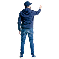 Wall Mural - A man in jeans and jacket standing looking showing pointing on white background isolation, back view