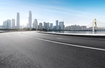 The expressway and the modern city skyline are in guangzhou, China.