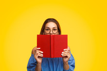 Woman In Glasses Holding Book Near Face