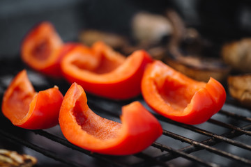 Wall Mural - close up of red fresh bell pepper slices grilling on barbecue grill grade