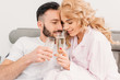© LIGHTFIELD STUDIOS - Happy couple celebrating anniversary and drinking champagne