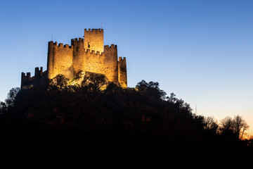 Wall Mural - Almourol, Portugal - January 12, 2019: Almourol castle at dusk and illuminated by artificial light.