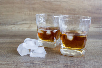 Two glasses of whiskey, bourbon in a glass. Alcoholic drink. Whiskey with ice