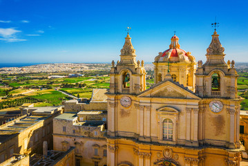 Wall Mural - Aerial view of church in Mdina city - old capital of Malta. Greeny Winter Malta island. Morning time. Landscape view