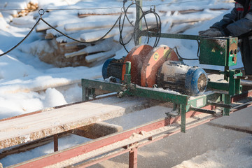 Wall Mural - Sawing boards on the sawmill. Cook lumber in winter. Work on the sawmill.