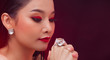 © Jade - Beautiful Young Asian black hair fur woman in fire red screen, high glitter fashion make up, studio lighting hot smoke burgundy background copy space, concept empty Big Karat Diamond Ring expensive