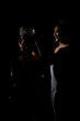 © Jade - Two Silhouette Shadow Back Rim Light of Miss Pageant Beauty Queen Contest put Silver Diamond Crown on Winner final moment most beautiful woman in world universe, studio lighting dark black background