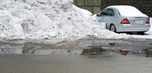 Parking Lots With High Snow Piles And Car Buried In Snow