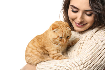 Young woman with her cute funny cat on white background