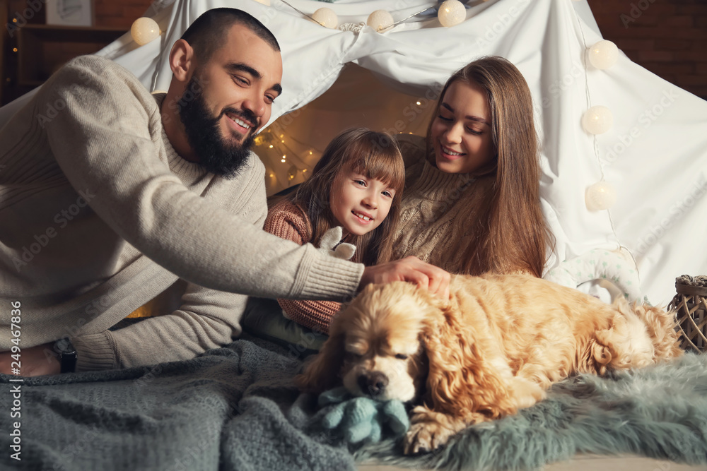 Happy family with cute dog at home