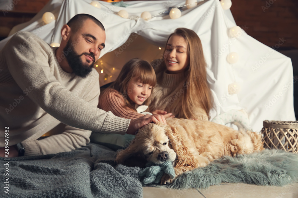 Happy family with cute dog at home