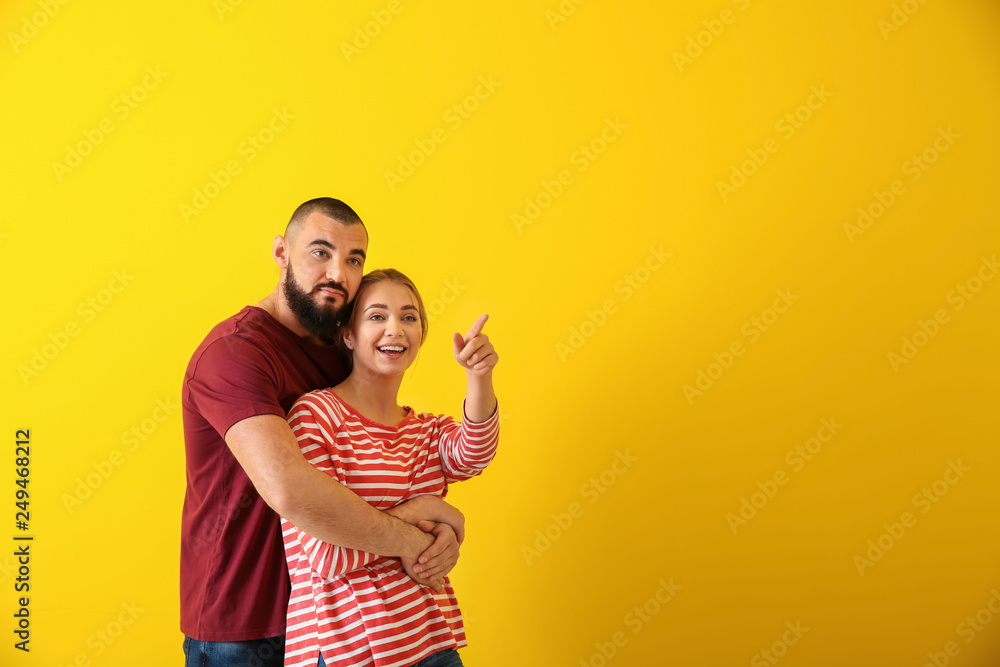 Portrait of young couple on color background