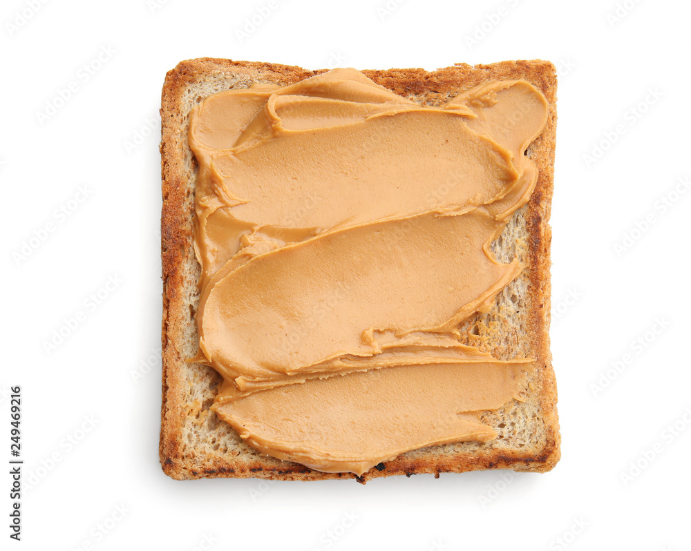 Piece of bread with tasty peanut butter on white background