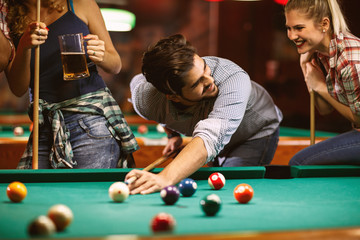 handsome smiling man playing billiard game.