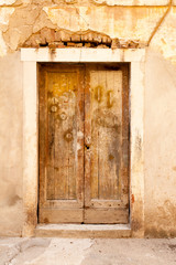 Aged shabby wooden door of the typical old building in Zadar, Croatia