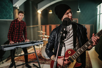 Wall Mural - Music band having rehearsal in a studio