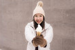 © siraphol - Beautiful young asian woman smile and happy with ice cream in snow winter season