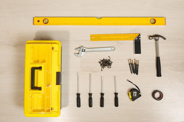 composed toolbox with instruments in order on wooden table, top view