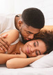 © Prostock-studio - Handsome man kissing woman on cheek under in bed