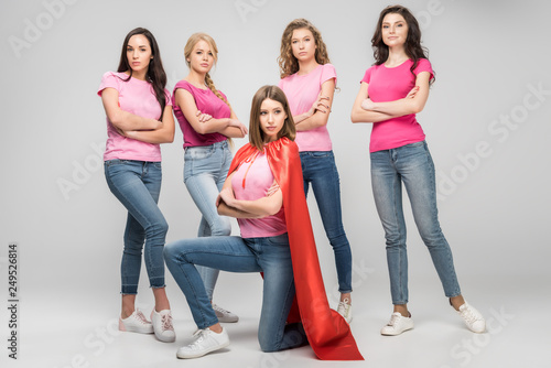 Cuadros en Lienzo confident girl wearing red superhero cape sitting near attractive women with cro