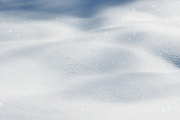 Fresh snow background texture. Winter background with snowflakes and snow mounds. Snow lumps.