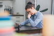 © LIGHTFIELD STUDIOS - sad woman in blue blouse sitting at wooden table, looking at photo and crying in  kitchen, grieving disorder concept