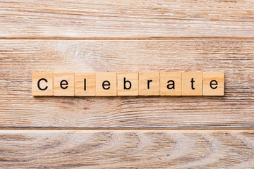 Celebrate word written on wood block. Celebrate text on wooden table for your desing, concept