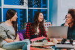 © Yakobchuk Olena - Happy three girlfriends having conversation in room