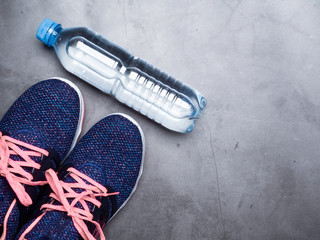 Sport shoes and water bottle. Fitness concept