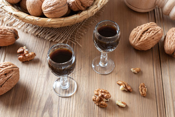 Homemade nut liqueur with walnuts on a table