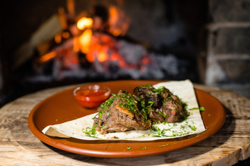 Wall Mural - fried meat with sauce on fire background