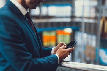 Wall Mural - Unrecognizable man holding new cellular phone in hands