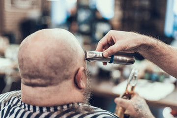 Wall Mural - Professional cutting customer head using electric machine