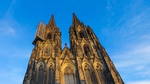 Front Of Cologne Cathedral With Scaffold Against Blue Sky