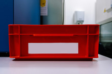 Red Box With A Black Label On A Lab