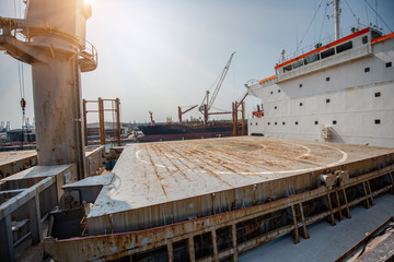 Wall Mural - hatch cover, derrick industrials crane and accomodation of the commercial ship in dock yard terminal for recondition and painting repairing