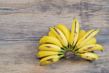 Delicious yellow ripe banana on wood texture background.