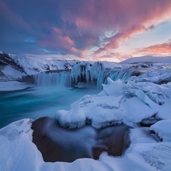 Wall Mural - godafoss waterfall at sunset - views around iceland, northern europe in winter with snow and ice. on