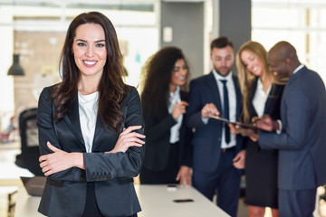 Wall Mural - Businesswoman leader in modern office with businesspeople working at background