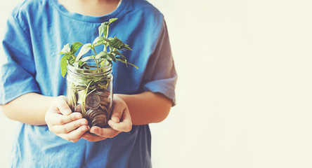 child saving money in Bottle money growing up as tree