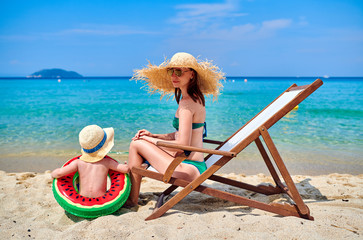 Toddler boy on beach with mother