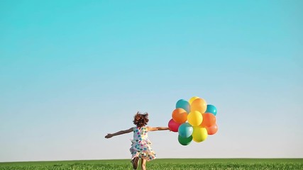 Sticker - Happy child playing with bright multicolor balloons outdoor