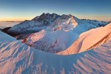 Wall Mural - Mountains panorama from the High Tatras, Slovakia Beautiful winter mountain landscape with colorful clouds after sunrise. Wonderful Carpathian mountains background concept. Amazing structures in snow.