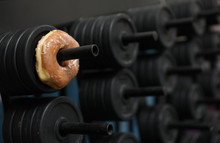 A Donut Is On A Weight Rack, A Metaphor For A Tough Life Choice