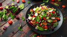 Traditional Fattoush Salad On A Plate With Pita Croutons, Cucumber, Tomato, Red Onion, Vegetables Mix And Herbs