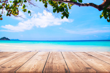 Wood table and beautiful sea with sand beach background